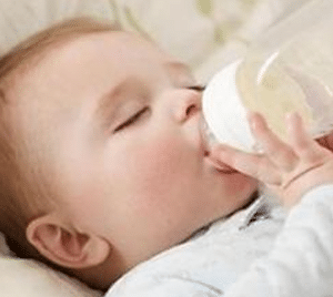 baby-holding-milk-bottle