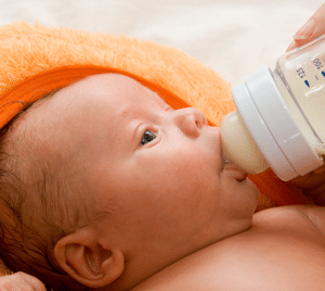 babysitter-feeding-milk-to-baby