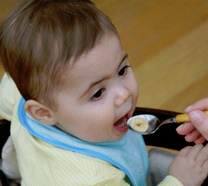 babysitter-spoon-feeding-baby